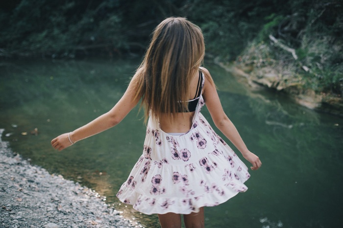 Woman in summer dress by the water