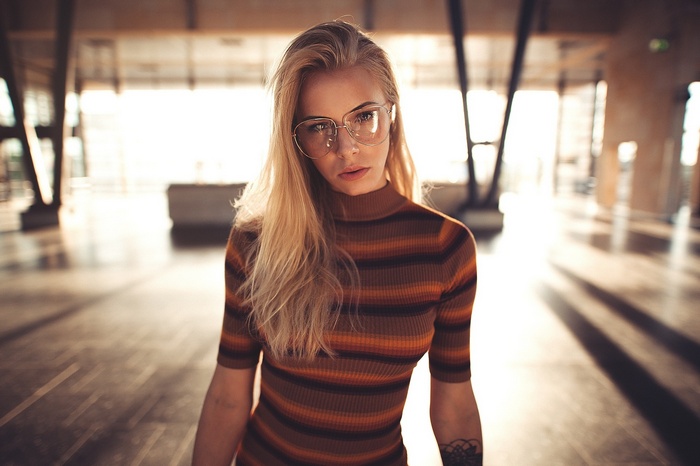 Woman with glasses and tattoo by Sebastian Heberlein