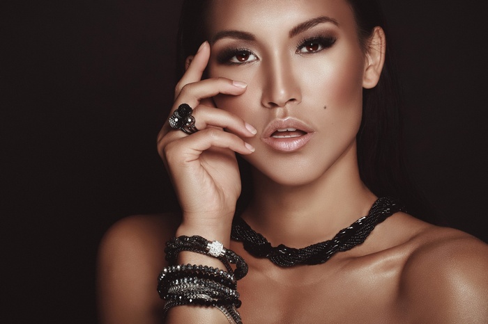 Woman with dark jewelry and makeup