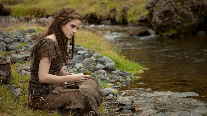 Emma Watson sitting by a stream