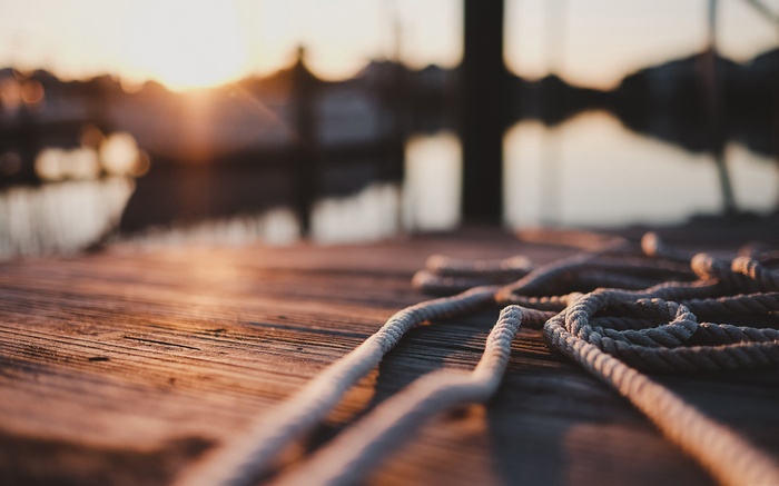 Ropes on a wooden dock at sunset
