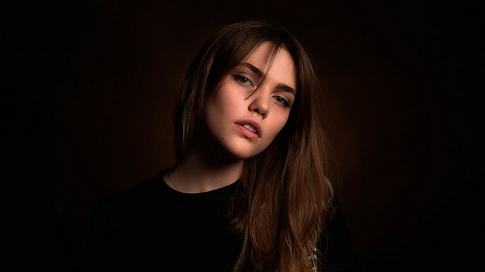 Woman with brown hair and black clothing
