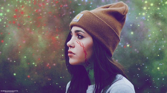 Woman wearing a Carhartt beanie with abstract background