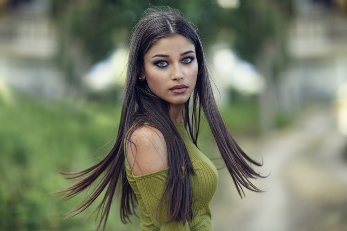 Brunette woman with blue eyes outdoors