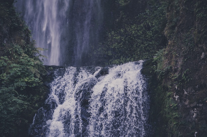 Waterfall cascading over rocks with lush greenery