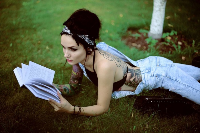 Aga Czech reading a book on the grass