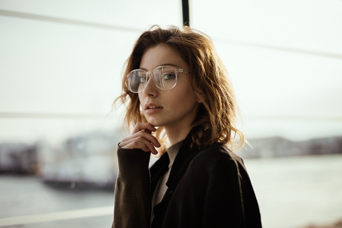 Woman with glasses looking at the viewer