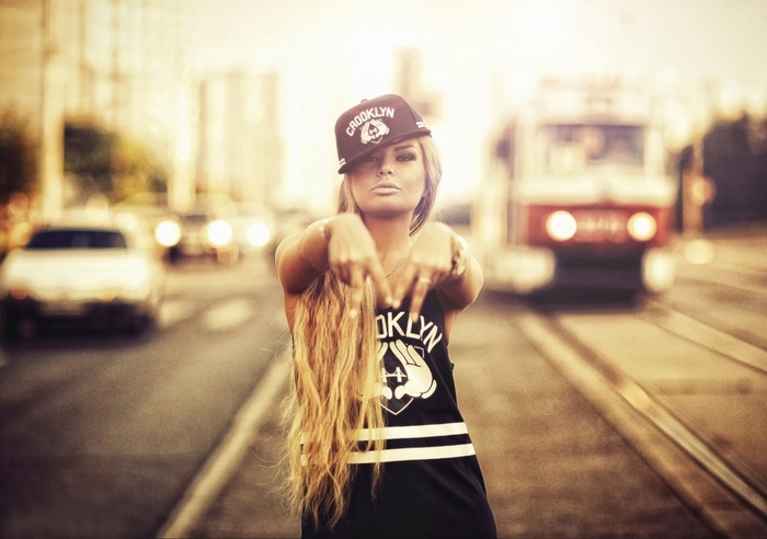 Woman in Brooklyn tank top and cap on a street