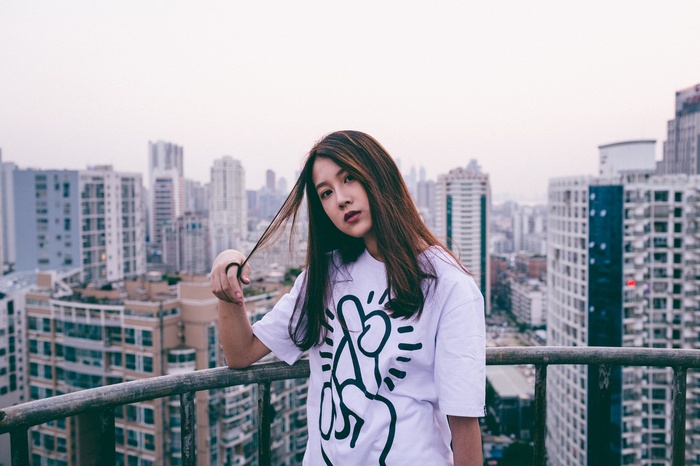 Woman on a balcony overlooking a cityscape in China