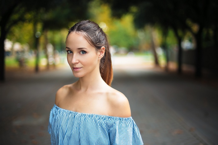Portrait of Lorenza with auburn ponytail, bare shoulders