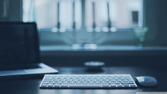 Laptop, keyboard, and mouse on a desk