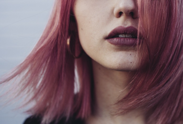 Woman with pink dyed hair and dark lipstick