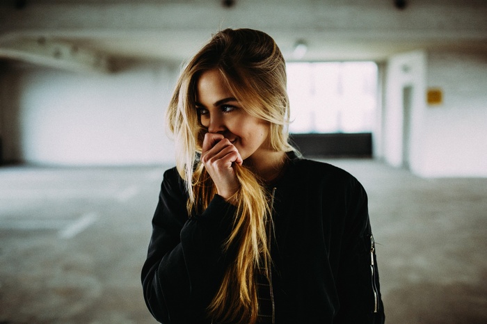 Woman with blonde hair in a parking lot