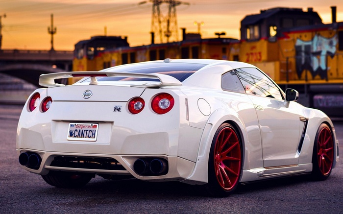 White Nissan GT-R R35 with custom red wheels