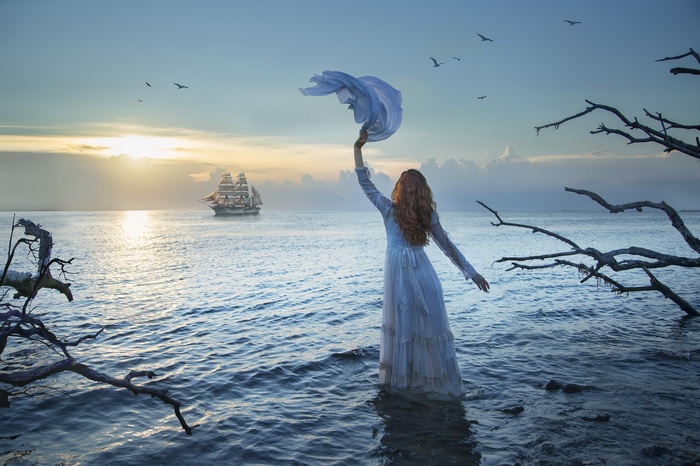 Girl with scarf and ship at sea