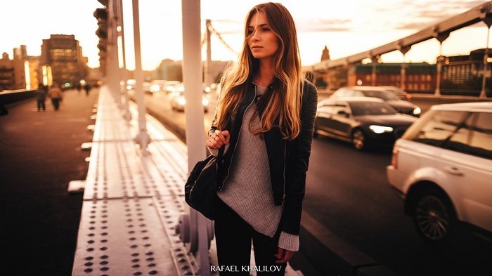 Woman with long blonde hair on a bridge