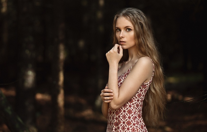 Woman with long wavy blonde hair in a dress