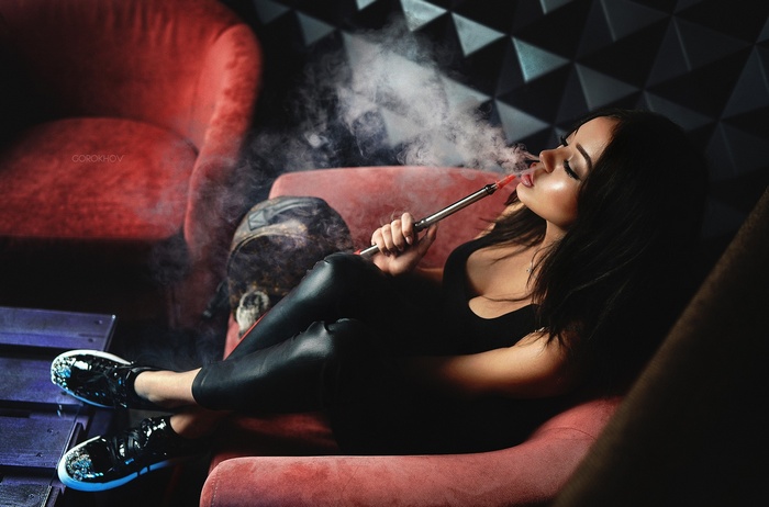 Woman smoking hookah in a lounge