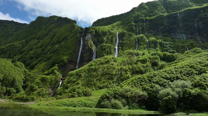 Green mountains with many waterfalls and a lake