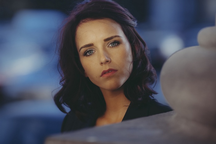 Woman with blue eyes and dark hair looking at viewer