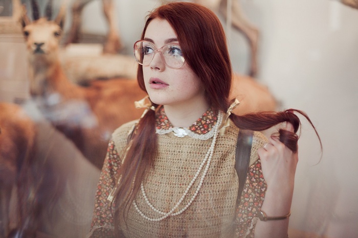 Redhead woman with glasses and pigtails