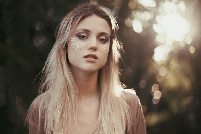 Woman with blonde hair and glitter on her face