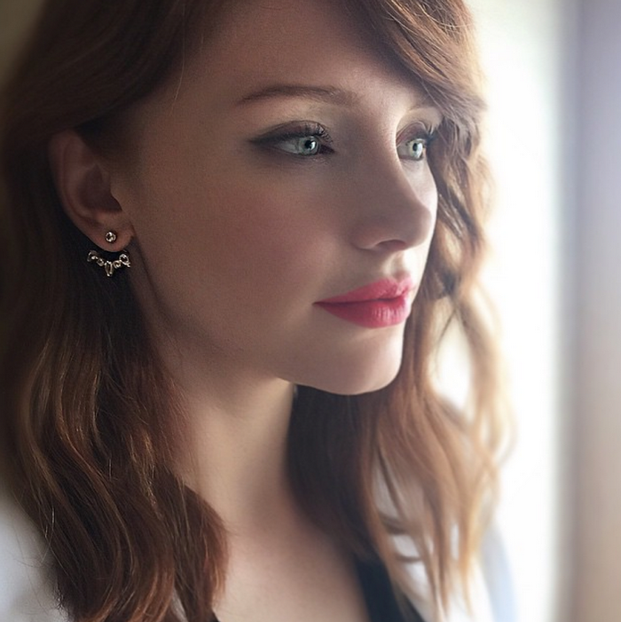 Bryce Dallas Howard wearing earrings and red lipstick