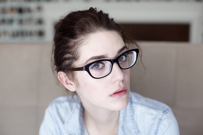 Woman with glasses looking at the viewer