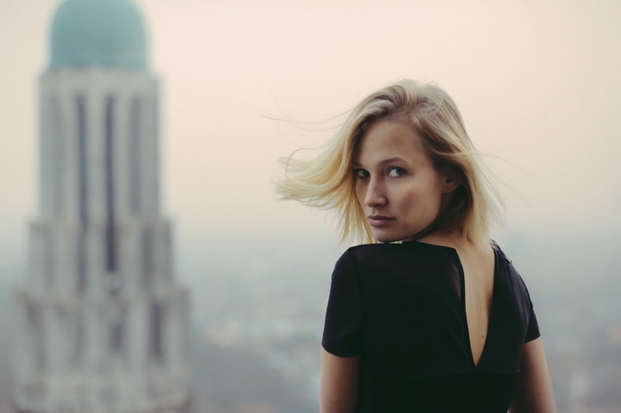 Woman with blonde hair looking over her shoulder