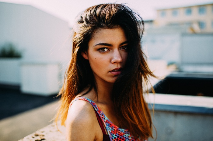 Woman with hair in face looking at viewer