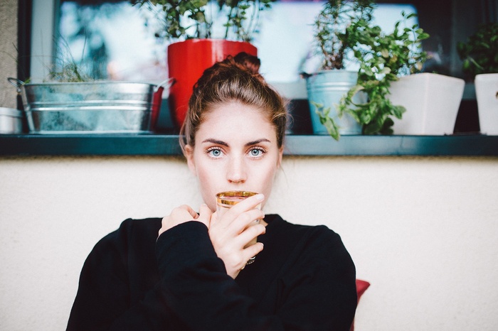 Woman with blue eyes drinking from a glass