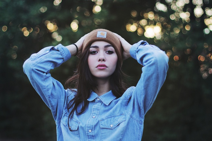 Woman wearing a Carhartt beanie and denim shirt