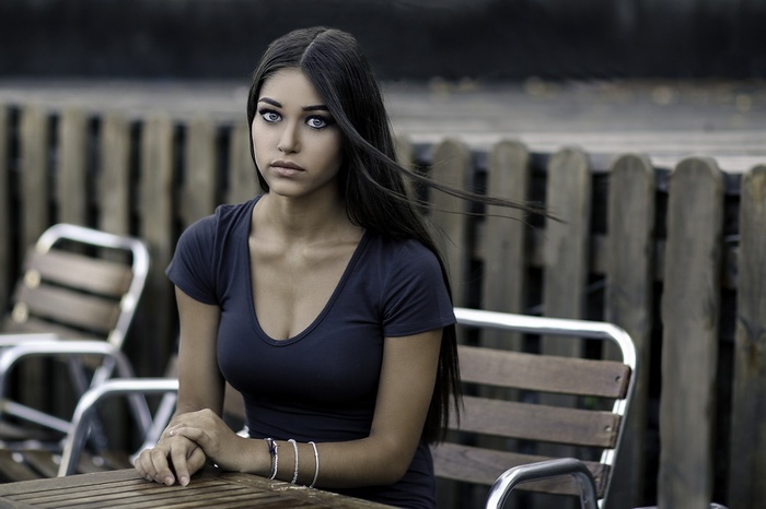 Woman with blue eyes sitting at a table