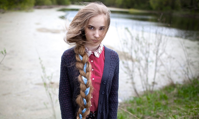 Woman with long braid and blue ribbons