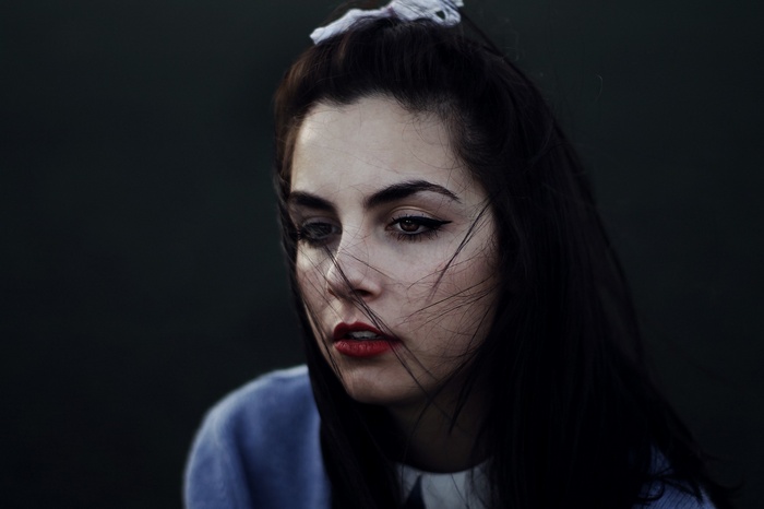 Woman with dark hair and red lipstick