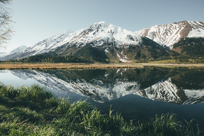 Snow-capped mountains reflected in a calm lake