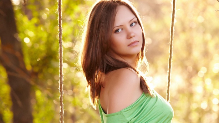 Woman on a swing in sunlight