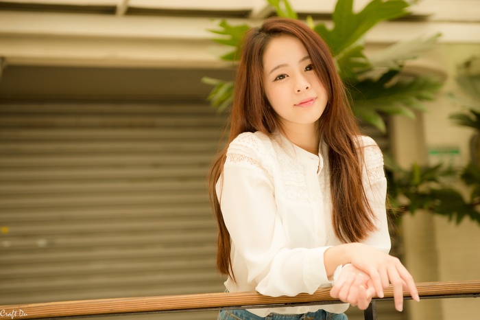 Portrait of an Asian woman in a white shirt