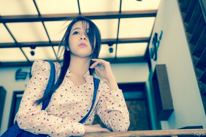 Asian woman with dark hair looking up