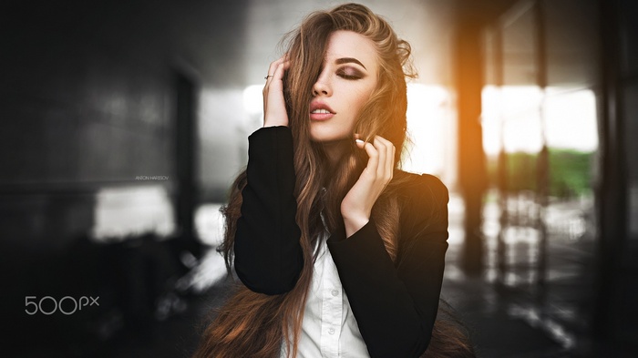 Portrait of a woman with long hair and closed eyes