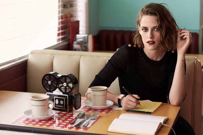cup, long hair, Chanel, table, women, open mouth, see-through clothing, brunette, camera, sitting, pens, actress, Kristen Stewart, celebrity, coffee, watch, cafeteria , writing, books, black dress, looking at viewer
