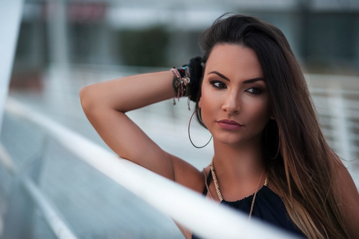 Woman with hoop earrings and bracelets outdoors