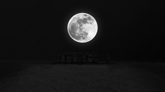 Stonehenge under a full moon at night