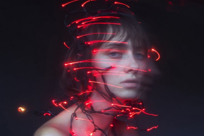 Woman with red Christmas lights around her head