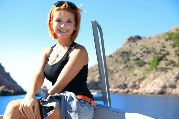 Young woman with orange hair on a boat