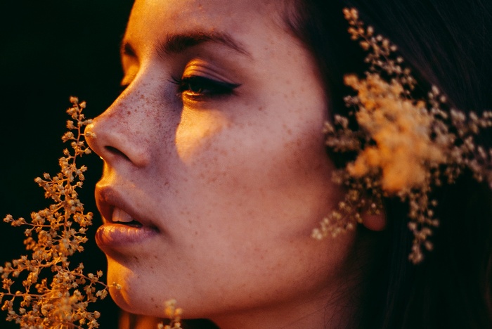 Woman with freckles and flowers in her hair