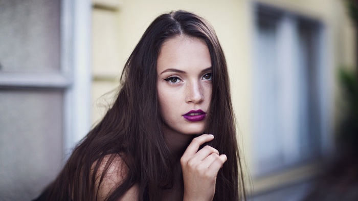 Ruby James with purple lipstick and freckles
