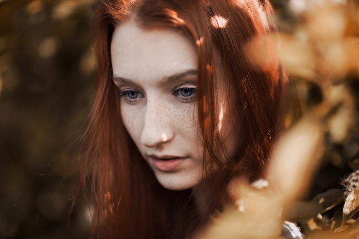 Redhead woman with freckles and blue eyes