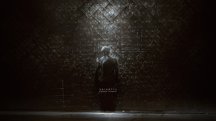 Kuldar Leement standing in front of a blackboard with equations