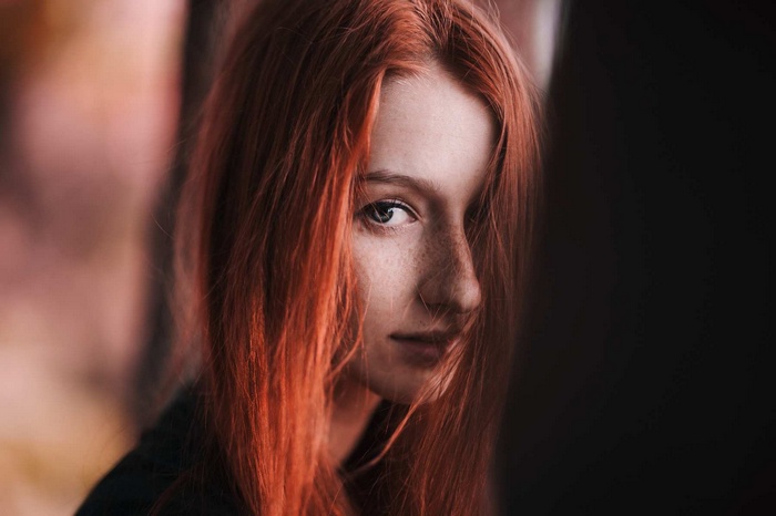 Redhead woman with freckles and blue eyes